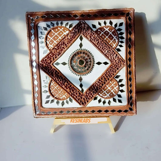 LippanGlow handcrafted mud and mirror art piece with intricate patterns and vibrant colors displayed on easel.
